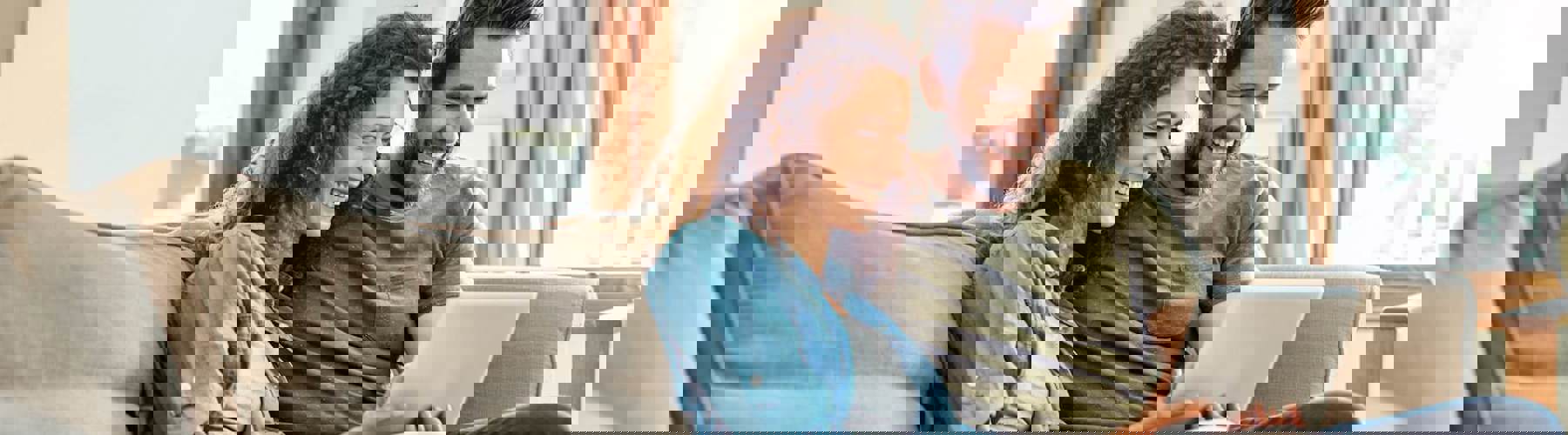 Couple on couch with tablet